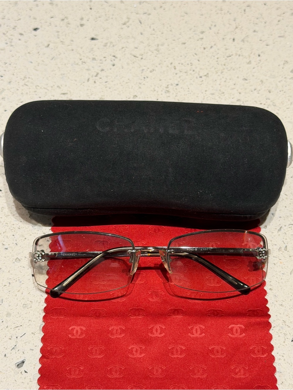 CHANEL Silver Rimless Men’s Glasses with Black Temples